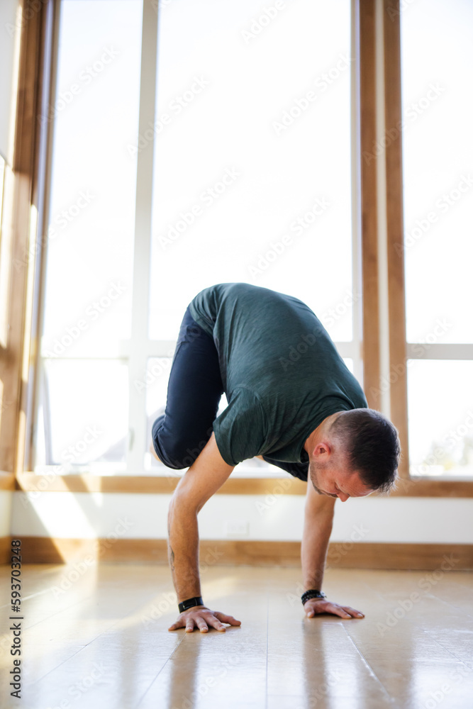 Difficult crow pose in yoga studio. Difficult crow pose in yoga studio.