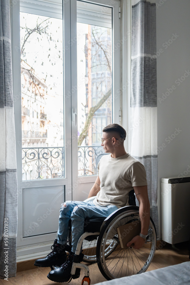 Young Man With A Disability Reading A Book Young Man With A Disability Reading A Book