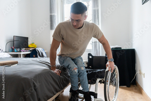 Man With Paraplegia Getting Into His Wheelchair