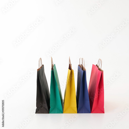 Colored craft bags on a white background. Place for text and logo. The concept of shopping, packaging, gift. High quality photo