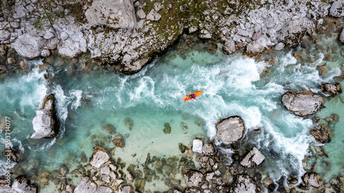 Photos Drone shot of whitewater kayaker dealing with crystal clear rapids of Soca river