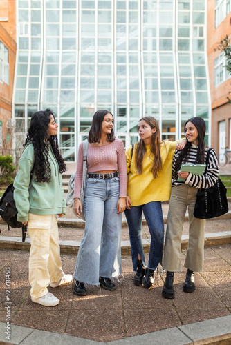 female student friends in front of the faculty at the university