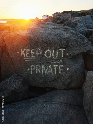 Paint inscription on the rocks - Keep out, private photo