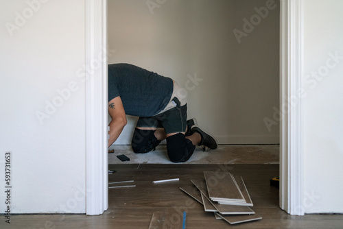 Unrecognizable man installing a wood floor photo
