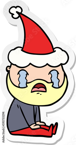 sticker cartoon of a bearded man crying wearing santa hat