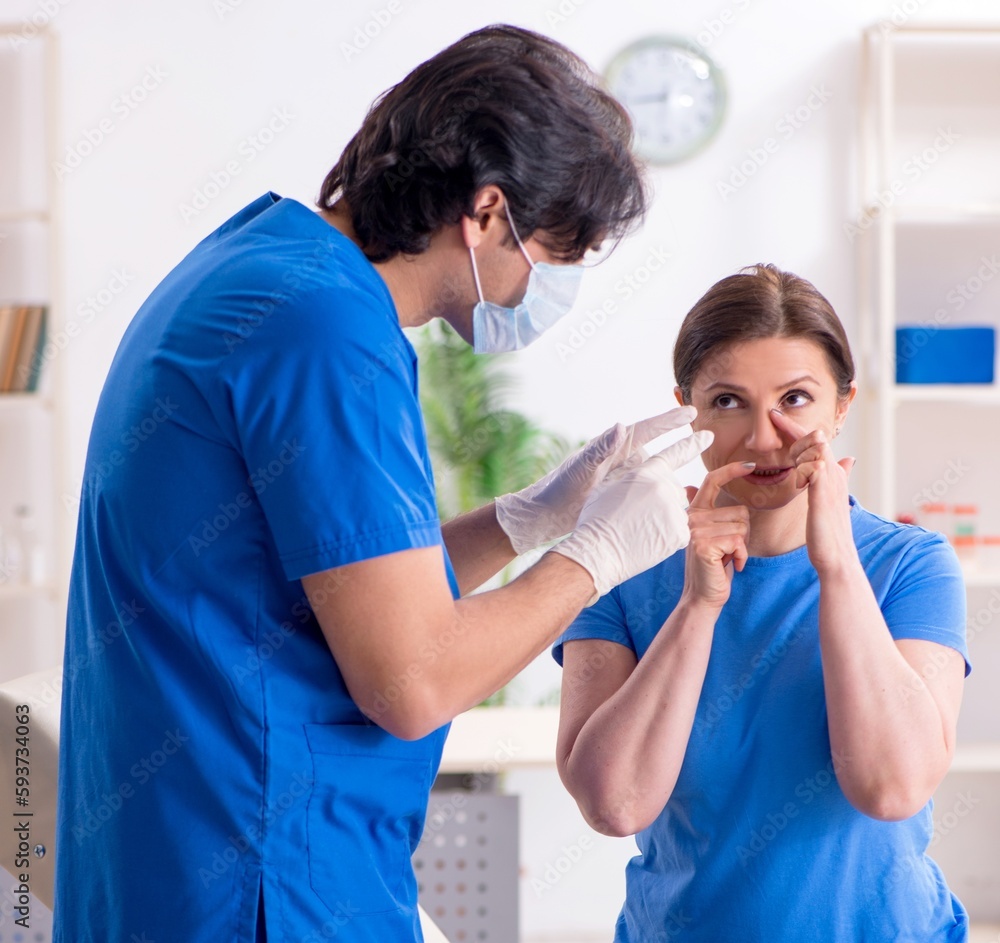 Fototapeta premium Woman visiting male doctor for plastic surgery