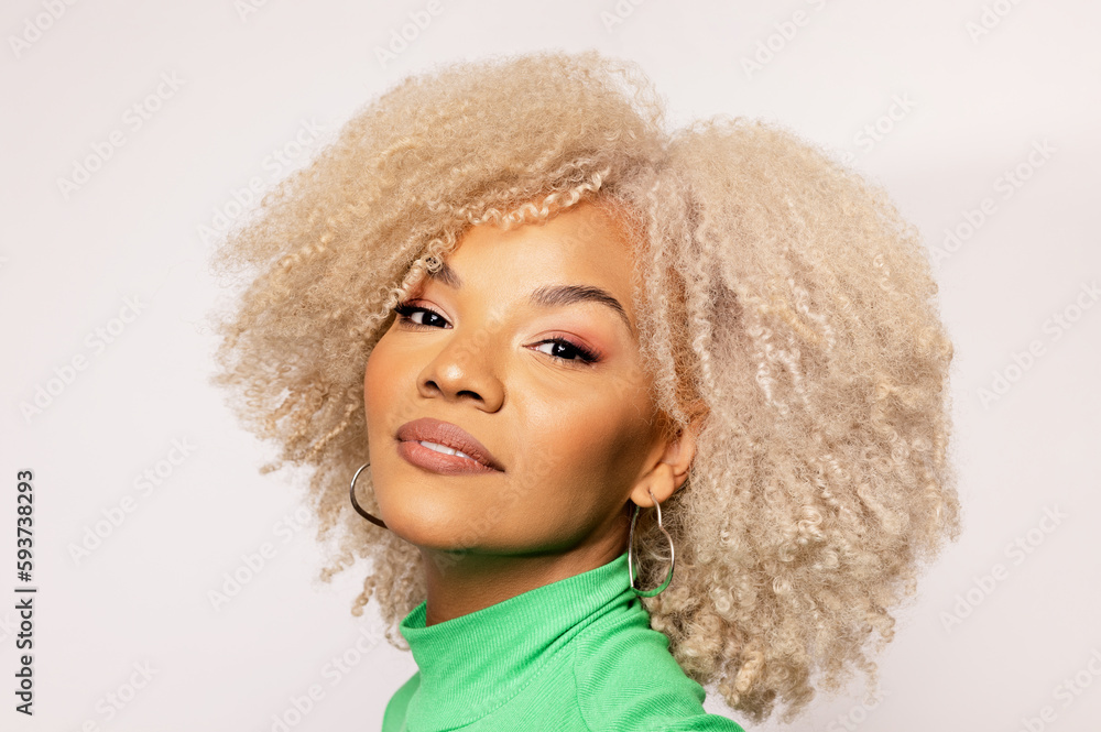 Latin woman with blonde afro hair looking at camera Latin woman with blonde afro hair looking at camera