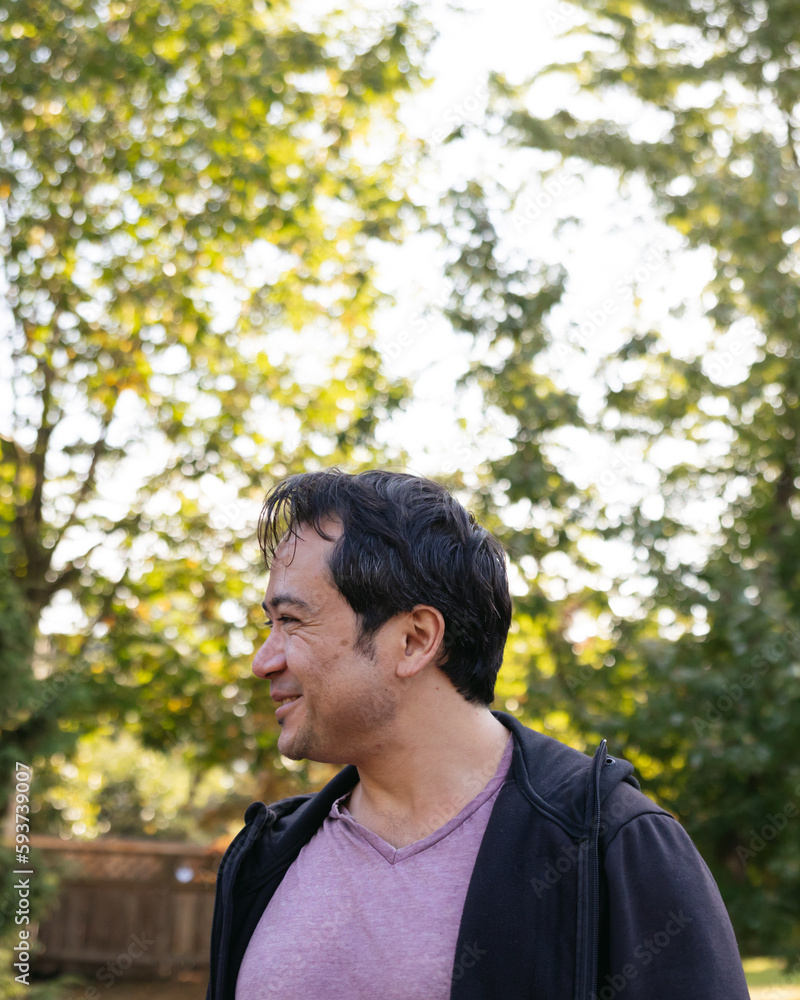Smiling man outside in nature park. Smiling man outside in nature park.