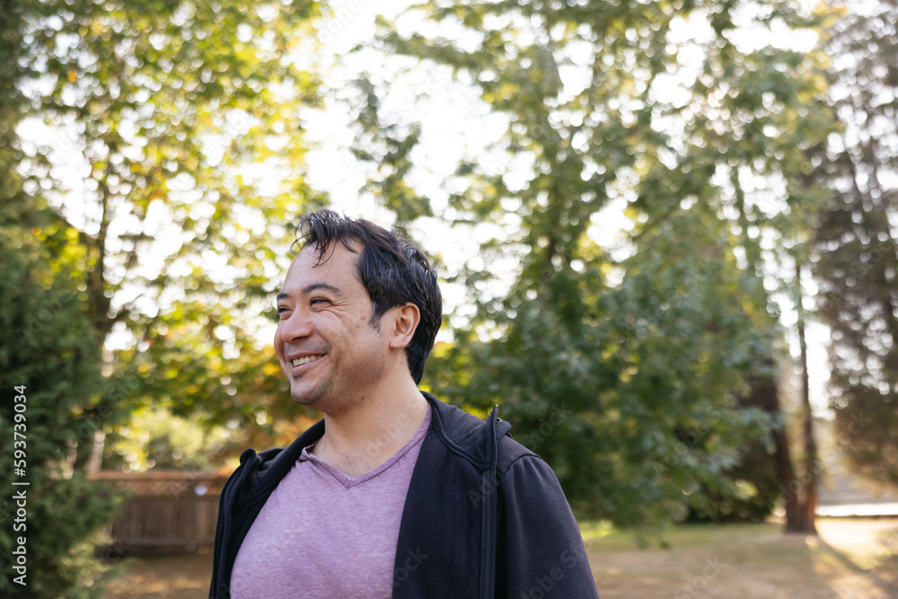 Smiling man outside in nature park. Smiling man outside in nature park.