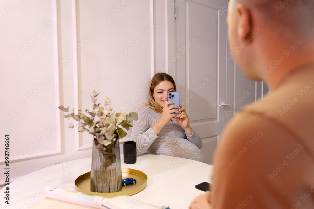 Pregnant Woman Taking A Photo And Husband Is Posing Pregnant Woman Taking A Photo And Husband Is Posing