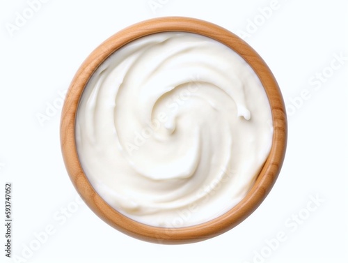 Sour cream in wooden bowl isolated on white background. Top view.