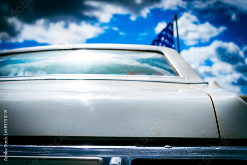 Retro old white car from back view with American flag