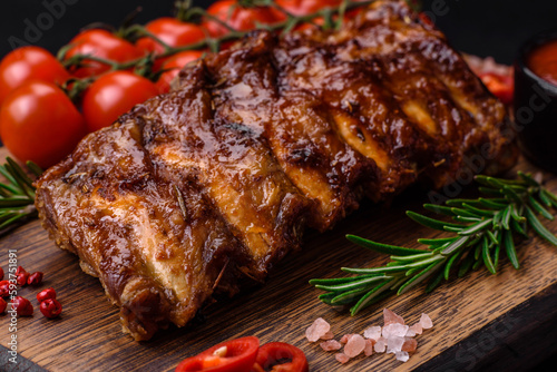 Delicious grilled pork ribs with sauce, spices and herbs