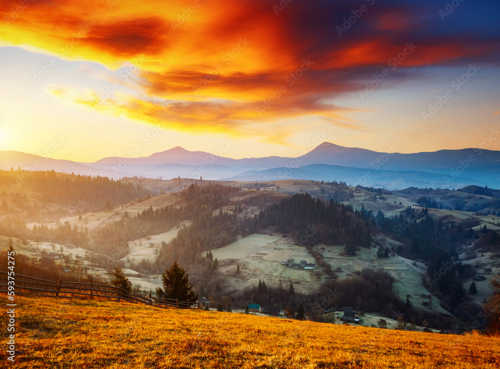Magical sunset in the mountains with warm rays of the sun. Carpathian mountains, Ukraine, Europe.