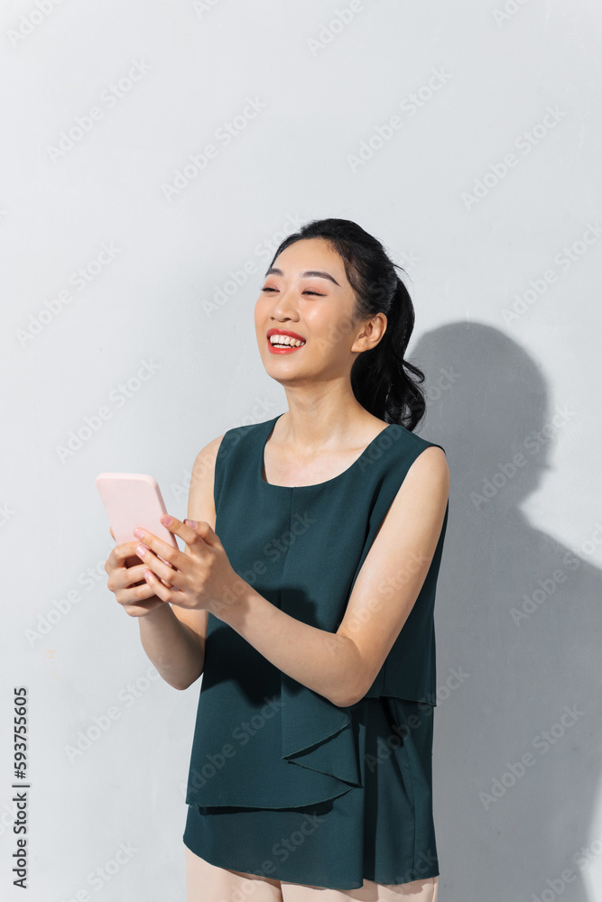 Beautiful smiling woman using smartphone over white background Beautiful smiling woman using smartphone over white background