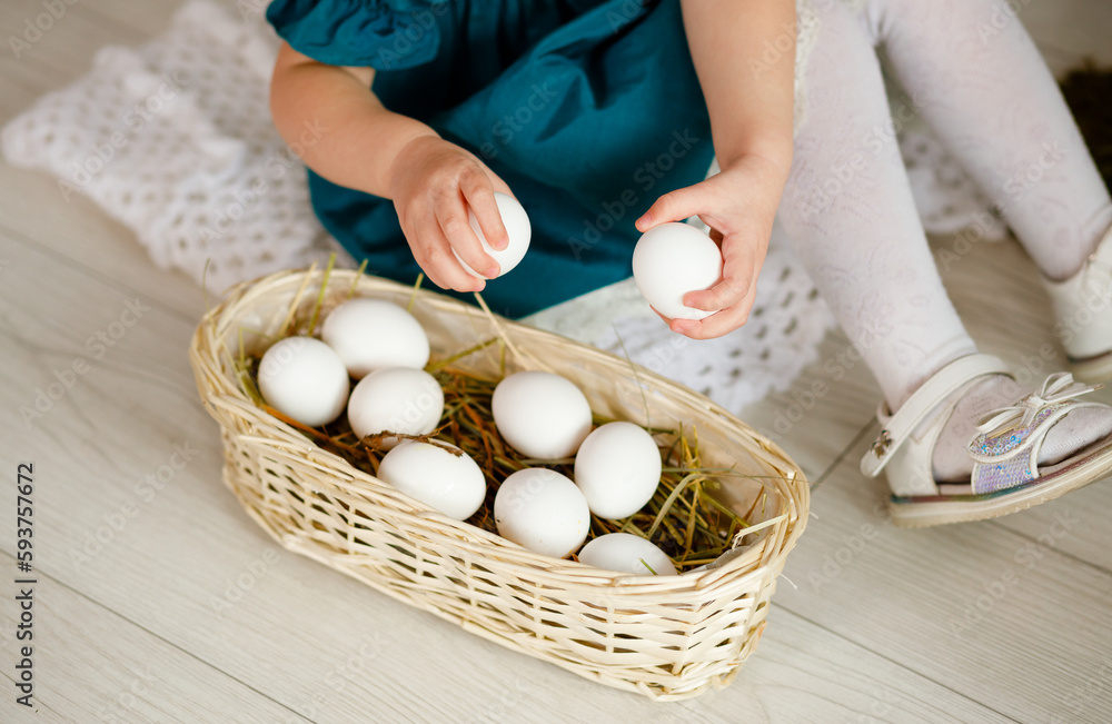 A girl in the village collects white chicken eggs in a basket. Easter Life in Ukraine A girl in the village collects white chicken eggs in a basket. Easter Life in Ukraine