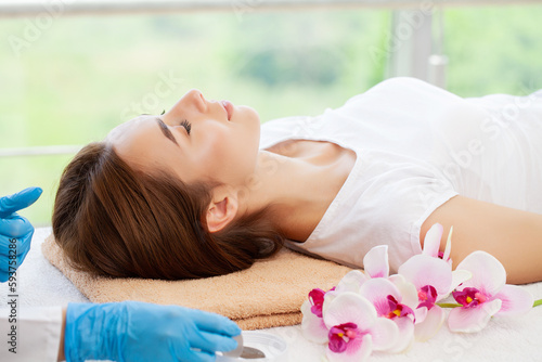 Young woman getting spa massage treatment at beauty spa salon