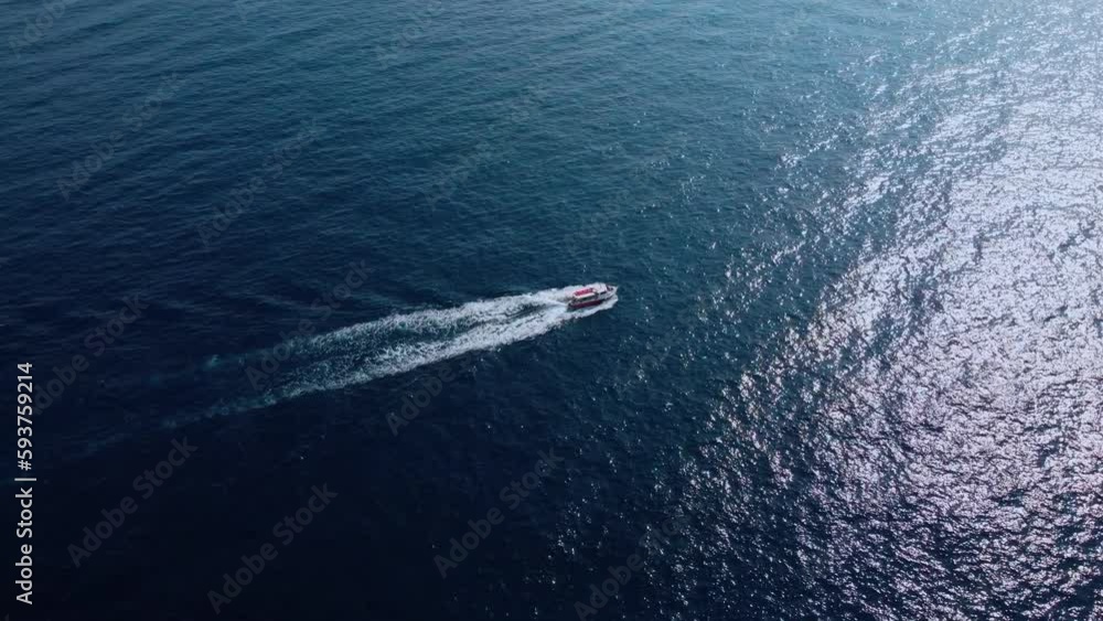 aerial view of a fast speedboats driving around in the circle and making beautiful shapes in the clear turquoise magical sea. Top travel destination. aerial view of a fast speedboats driving around in the circle and making beautiful shapes in the clear turquoise magical sea. Top travel destination.