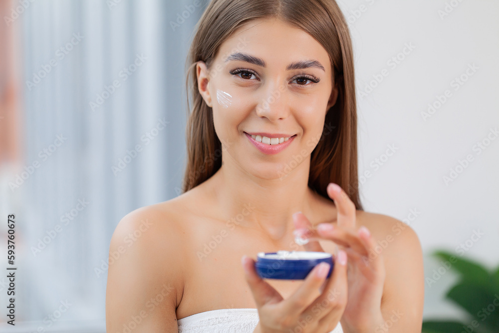 Skin care, woman use skin care products at home in light bathroom Skin care, woman use skin care products at home in light bathroom