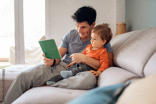 Dad teaching his son how to read