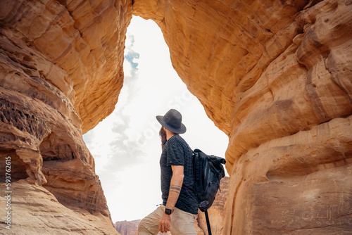 Unrecognizable explorer hiking in the desert of Saudi Arabia photo