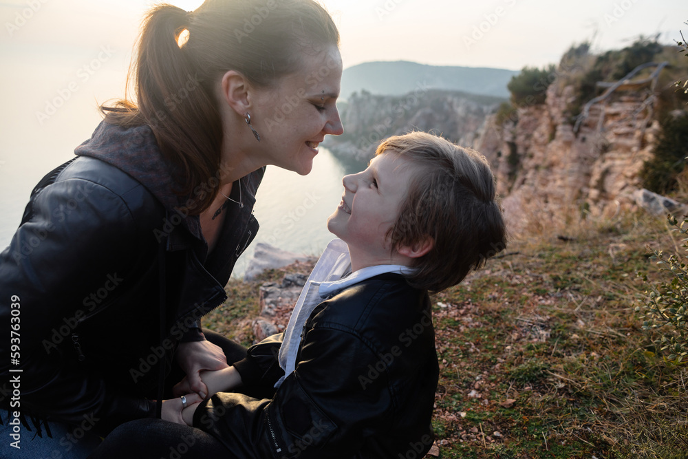 Laughing woman and her kid above the sea Laughing woman and her kid above the sea
