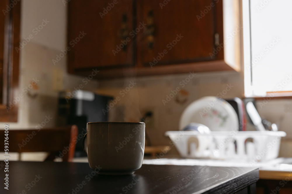 Steaming hot cup of tea or coffee on table. Steaming hot cup of tea or coffee on table.