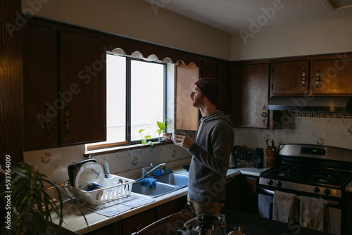 Man drinking coffee in retro kitchen.