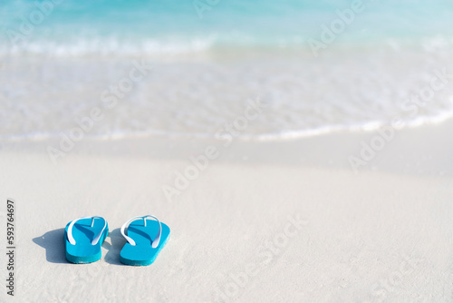 Flip flops on the beach on the background of ocean in the Maldives. Beach vacation