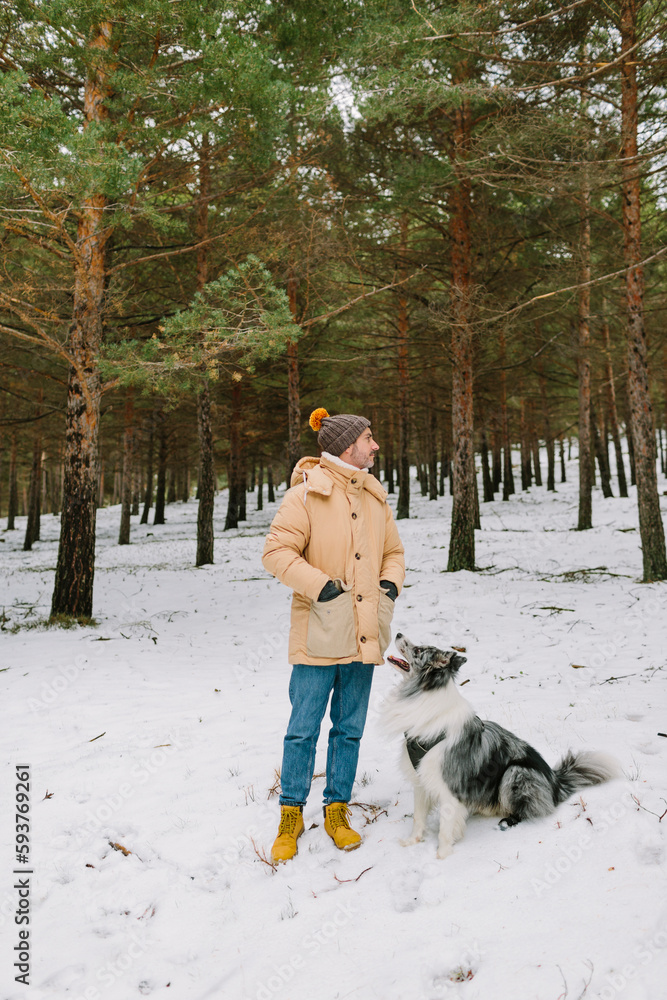 Man with a dog in the snow Man with a dog in the snow