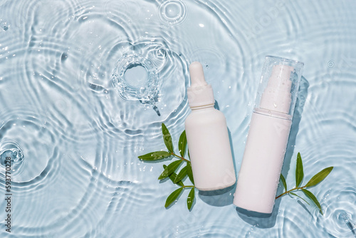 White bottle flacon cosmetics beauty product in water drop