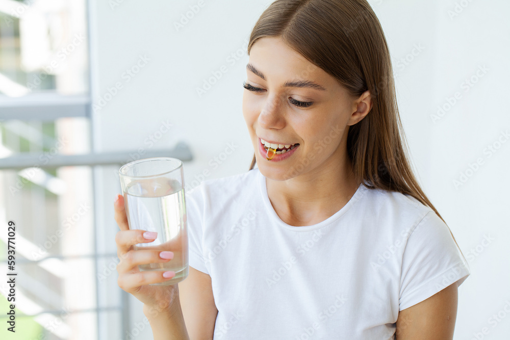 Beautiful Young Woman Taking Yellow Fish Oil Pill Beautiful Young Woman Taking Yellow Fish Oil Pill