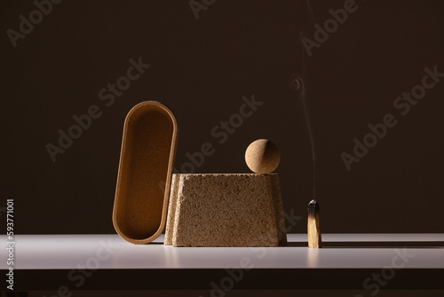 still life of architectural shapes in dramatic light with palo santo