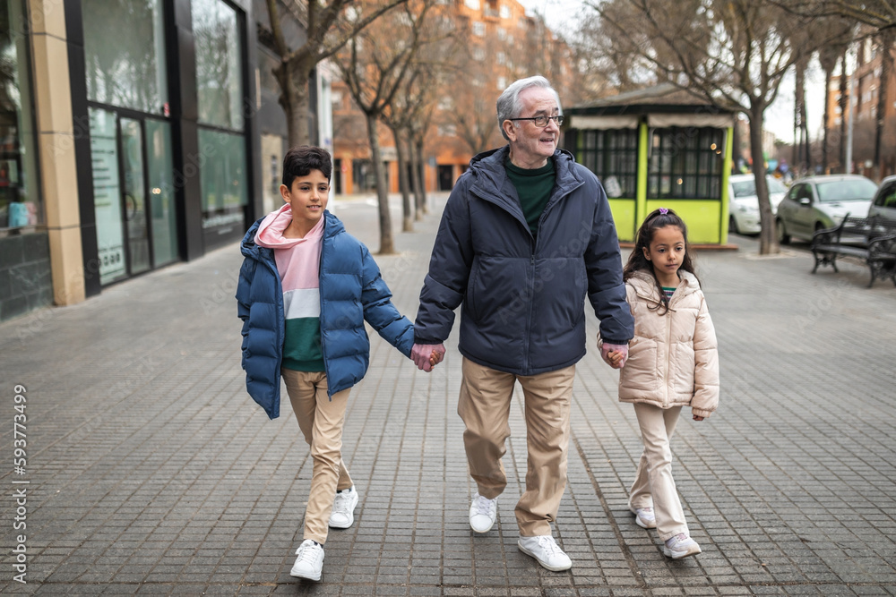 grandfather with grandchildren walking around the city grandfather with grandchildren walking around the city