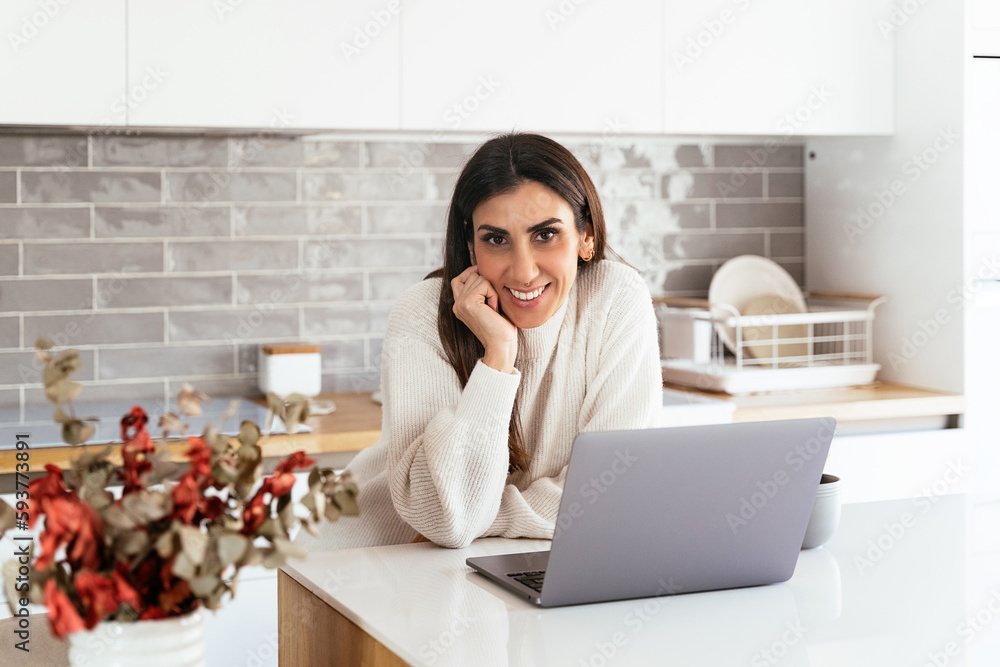 Positive woman in kitchen with computer Positive woman in kitchen with computer