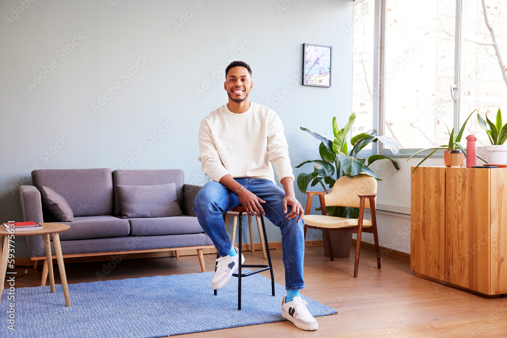 Positive black man sitting on bar stool Positive black man sitting on bar stool