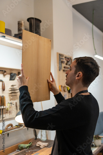 Luthier, Guitar Maker, Working In The Workshop.  photo