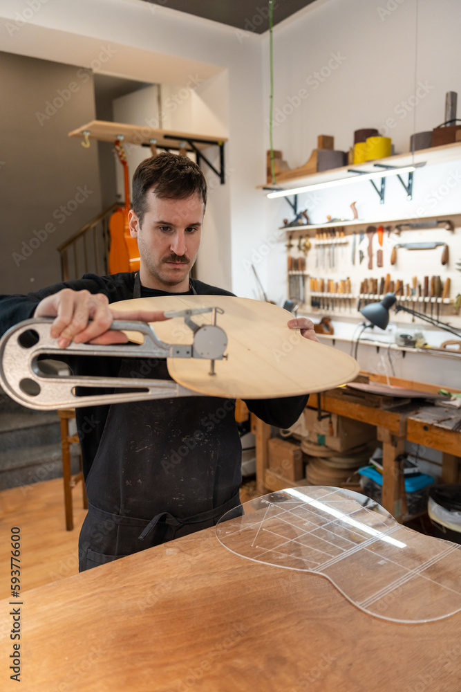 Luthier, Guitar Maker, Working In The Workshop. Luthier, Guitar Maker, Working In The Workshop.