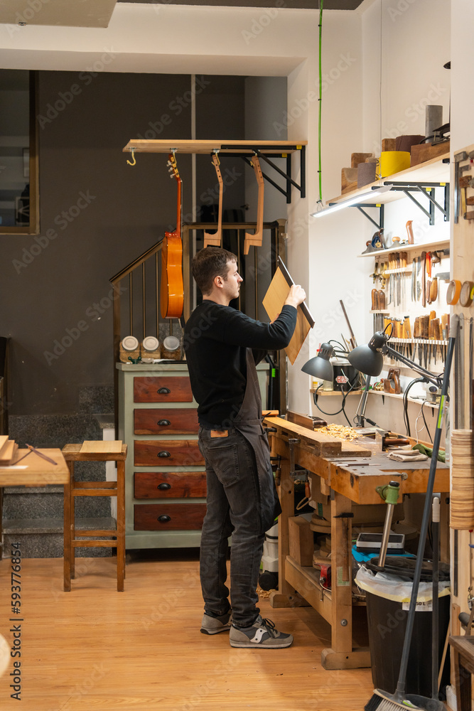 Luthier, Guitar Maker, Working In The Workshop. Luthier, Guitar Maker, Working In The Workshop.