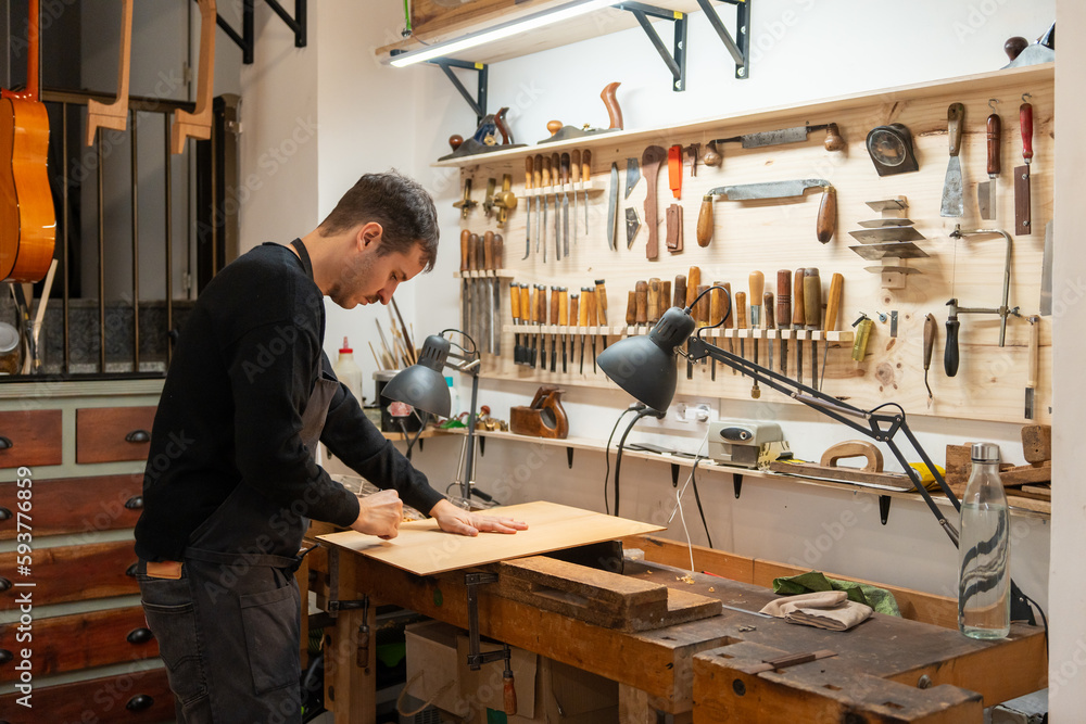 Luthier, Guitar Maker, Working In The Workshop. Luthier, Guitar Maker, Working In The Workshop.