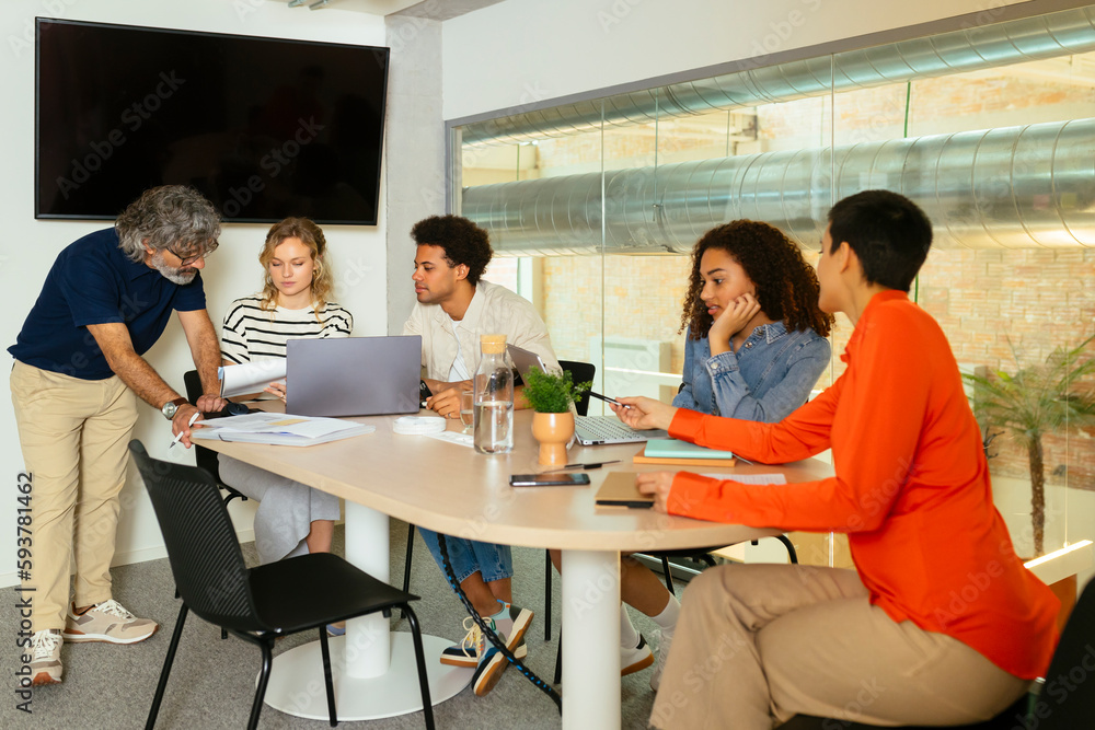 © BONNINSTUDIO/Stocksy - Group of diverse colleagues working on strategy in a office room