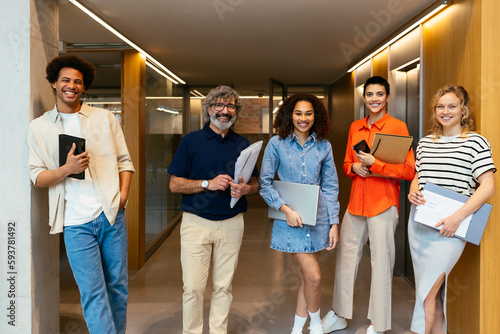 Smiling colleagues standing in workspace