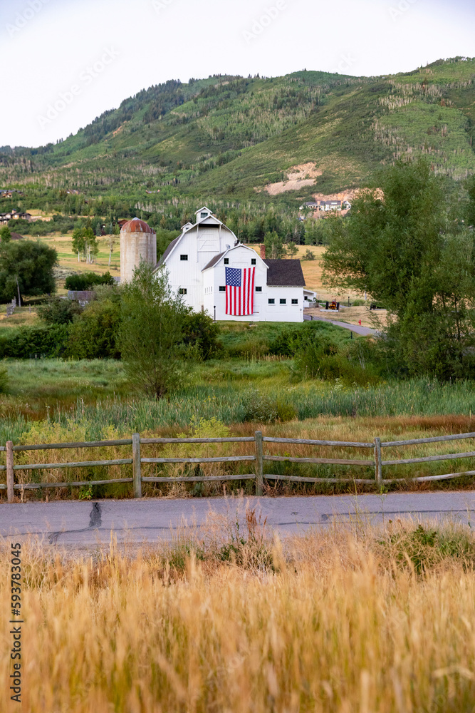 Vertical Image Park City Utah Barn farm landscape with American Flag Vertical Image Park City Utah Barn farm landscape with American Flag