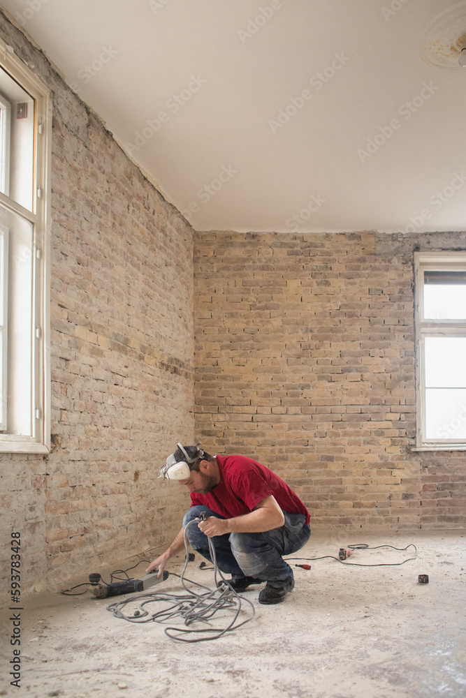 A construction worker in the apartment during a home renovation A construction worker in the apartment during a home renovation