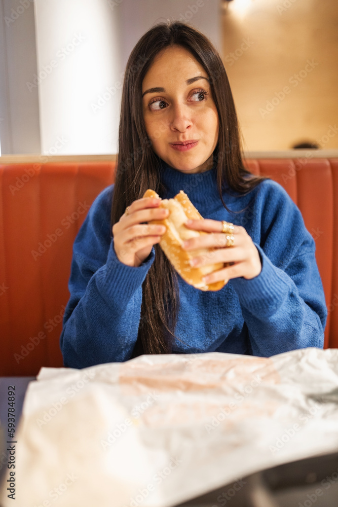 teenage girl having dinner in a restaurant teenage girl having dinner in a restaurant