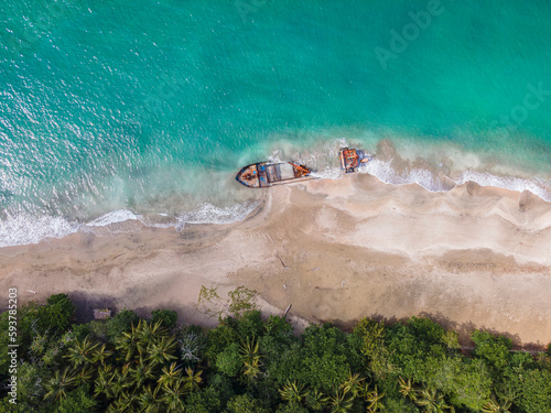 A ship stranded on the sand on the shore of the beach  photo