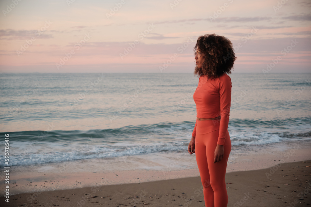 Sportswoman standing on the beach Sportswoman standing on the beach