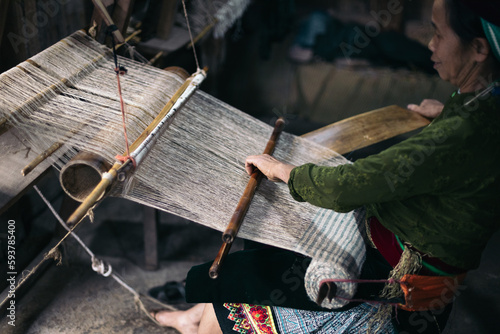 Traditional production: weaver woman working with a loom in a workshop photo