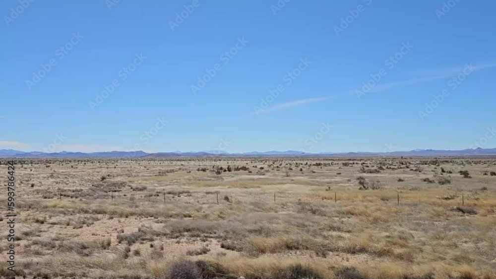 Drive plate-Passing barren plains of New Mexico with far distant mountains away on the horizon Drive plate-Passing barren plains of New Mexico with far distant mountains away on the horizon
