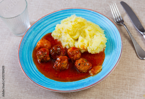 Nice tasty meatballs served with mashed potatoes and gravy on side